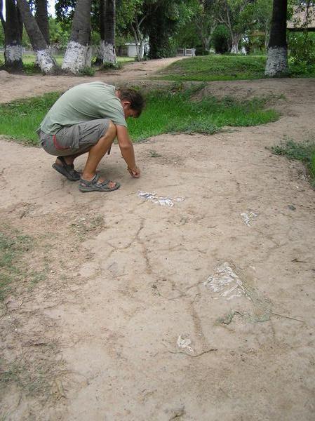 Examining fragments of clothing and bone - including teeth - at the killing fields