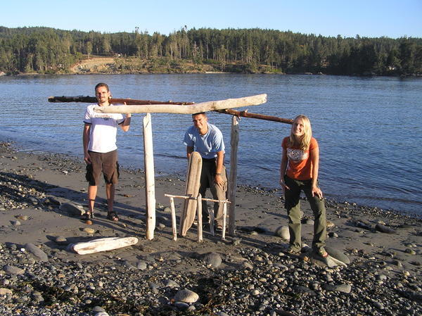 The finale to beach games is a driftwood sculpture & three big kids