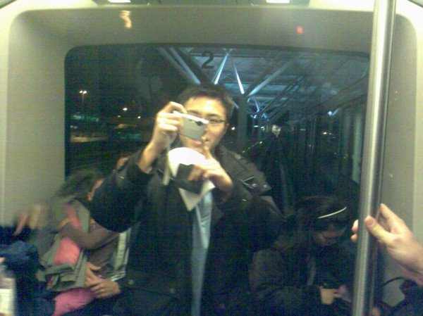 Yusen taking photos in the transit train