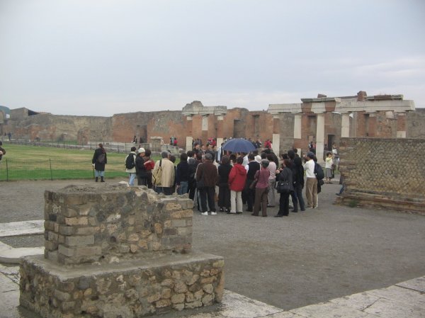 A big group of Asian tourists in the middle of the Forum