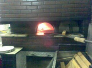 Our pizza roasting in the flame-licked oven
