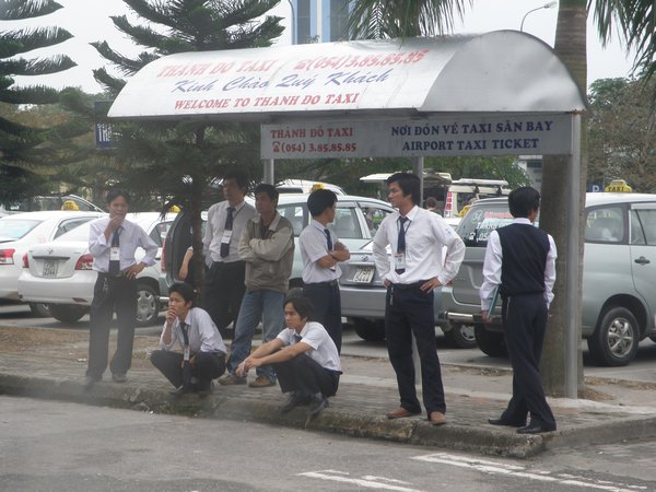 A group of taxi drivers waiting for customers