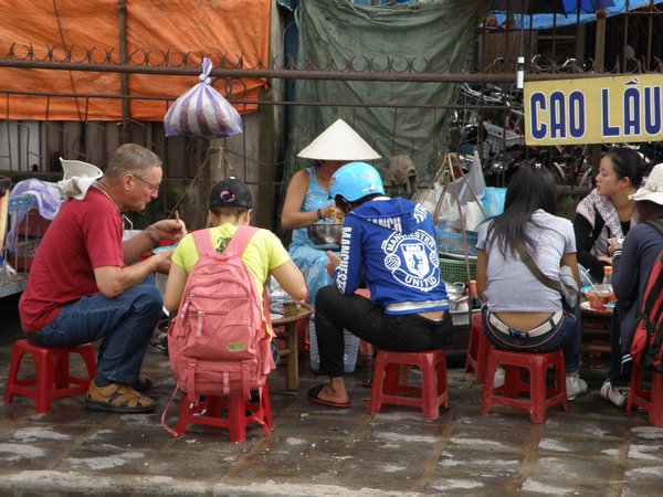 Foreigners joining the locals for cheap meals on the street