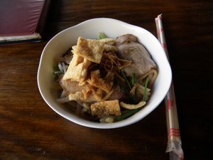 Cao Lau, a Hoi An specialty consisting of flat noodles topped with pork slices, crispy rice crackers and fried onions (Yum Yum!)