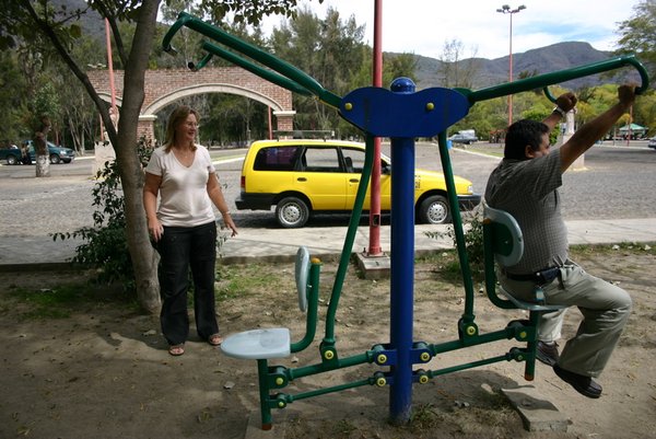 Our taxi driver trying out the exercise equipment in park in Jacotepec