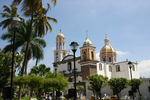 27 - View of the church across the square in Comala