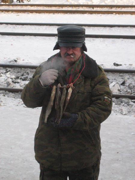 Russian comrade selling fish at a train station