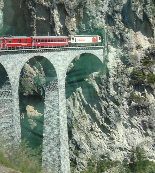 The Glacier Express crossing viaducts into a tunnel