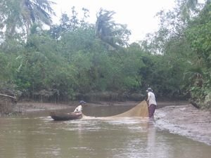 a husband and wife fishing the river