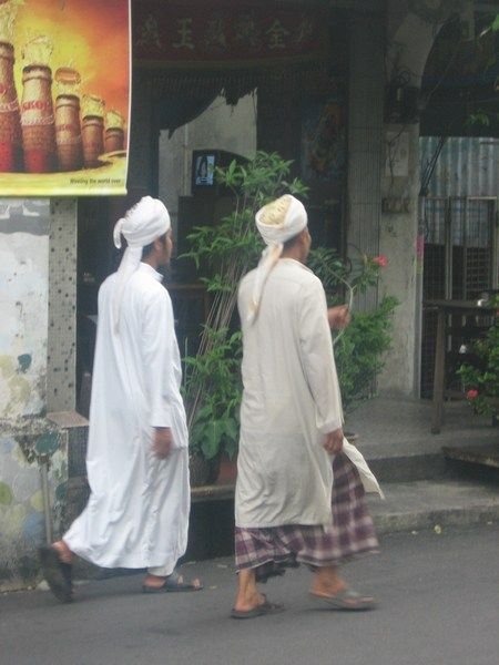 Locals walk down the steets of Penang