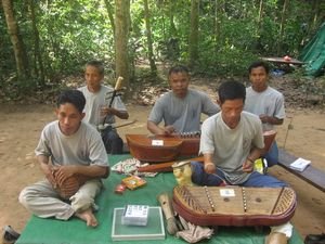 Handicap men sit along the paths of Angkor Wat and make music