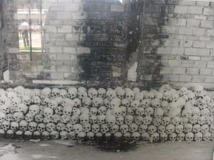 Hundreds of skulls stacked along a wall
