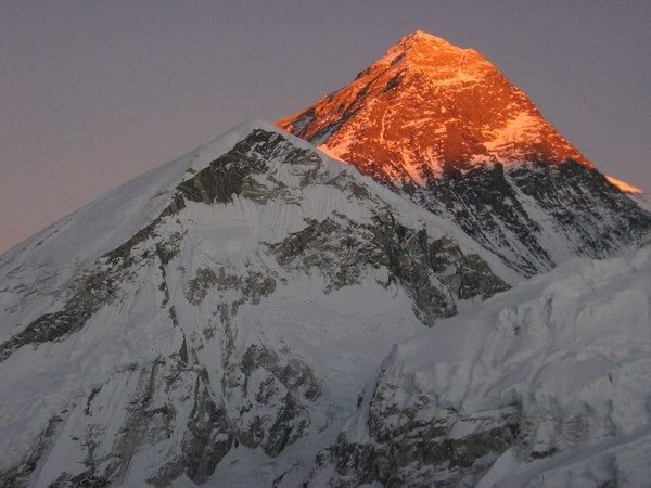 The summit of Everest glows red at sunset