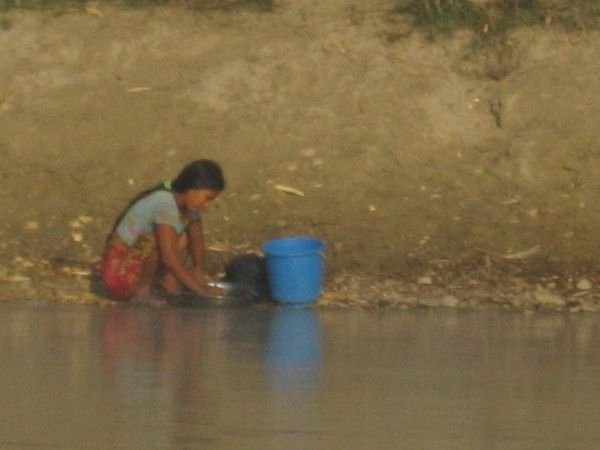 Washing dishes by the river's edge