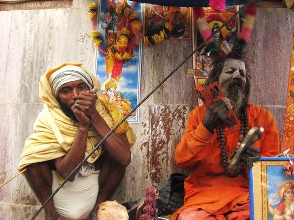 Two smoked out characters sit by the Brahman temple