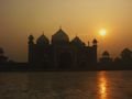 The sun reflects off of the marble ground surrounding the Taj