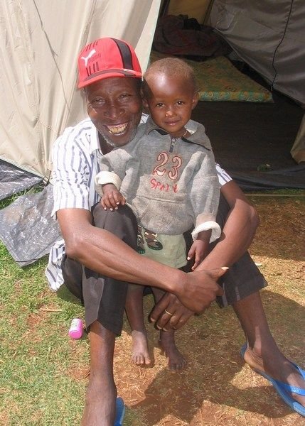 A man and his grandson at camp Limuru