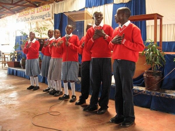 The IAA and Good Shepard boarders singing to the displaced families in Limuru