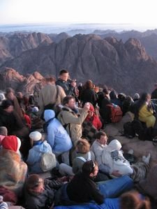 A crowd gathers to watch the sunrise from Mount Sinai