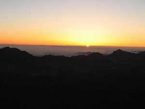 The first sign of the sun peeking over the horizon at Mount Sinai