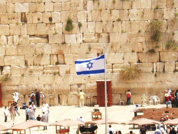 The star of David waving in front of the Wailing Wall