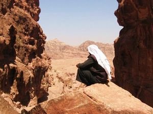 A Middleeastern man in deep thought on the cliffs of Petra
