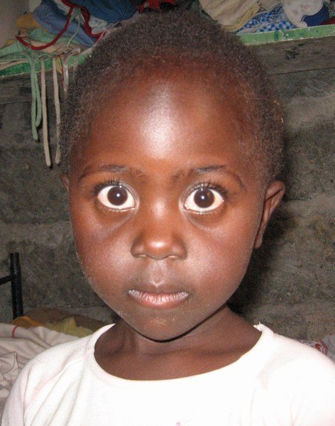 I believe this little girl just saw a ghost...or a funny looking Mzungu!