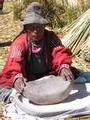 Elderly Woman Grinding Corn