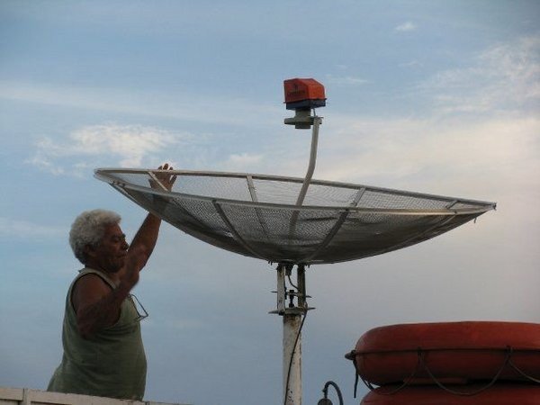 Adjusting the satellite dish to watch football on the boat