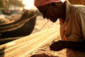 Fisherman repairing his nets, Fort Kochin