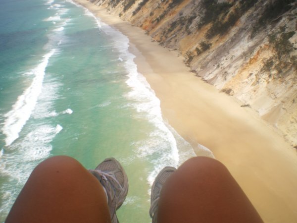My legs dangling over ocean