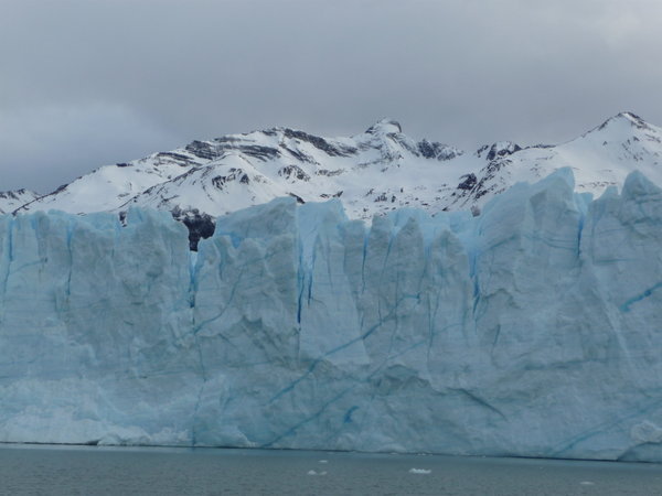 The blue of the glacier against the white of the snowy mountain
