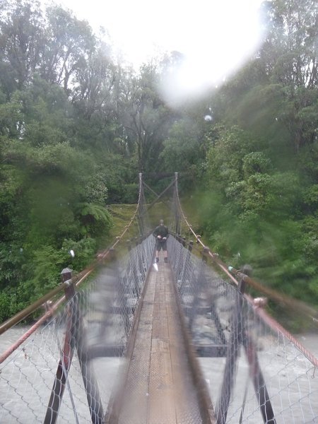 Steve on a bridge across the raging river