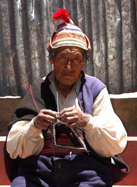 Old man in Taquile doing a spot of knitting