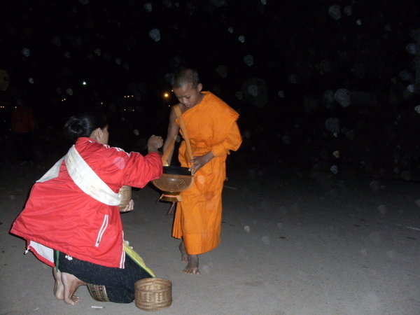 The comunity feeds the Monks that will in return pray for the village
