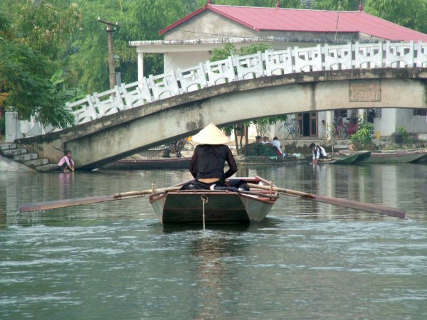 Lady rowing along the river