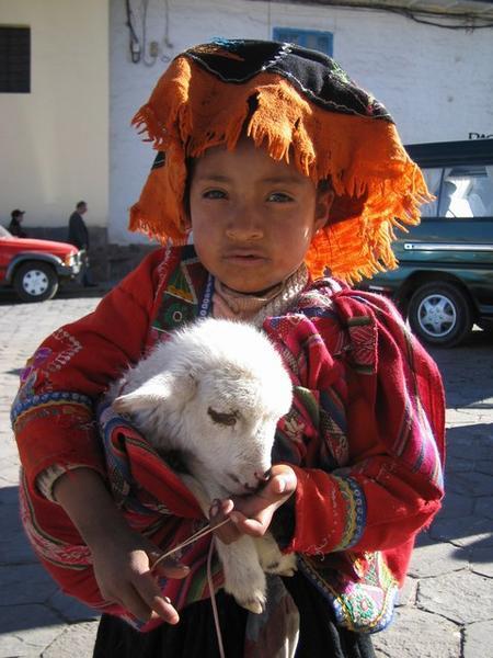Cusco girl hamming it up with a lamb