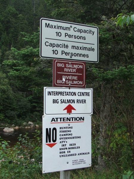 Signs by suspension bridge