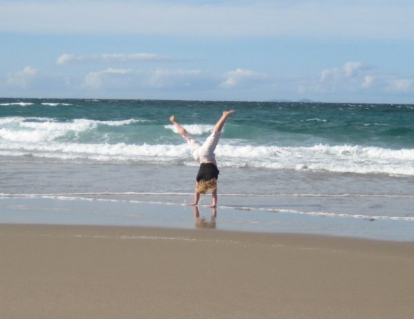 Debi cartwheeling at the beach