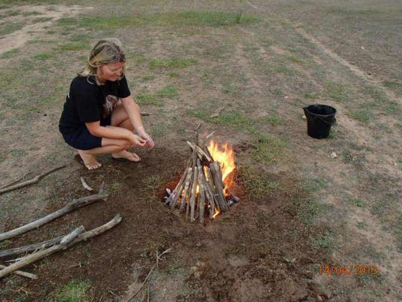 Caroline lighting the Camp fire