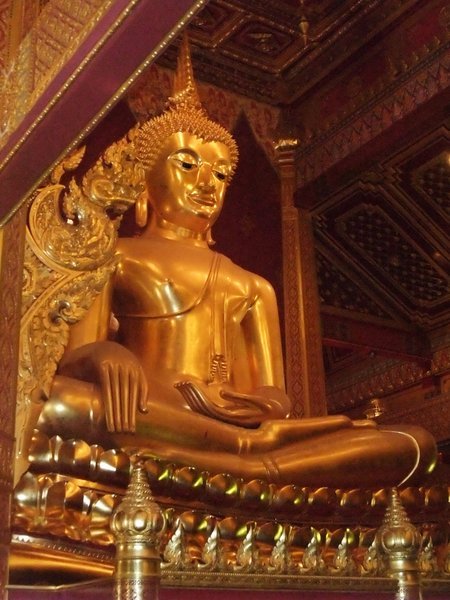 Gold plated Buddha statue in a temple towards Tak