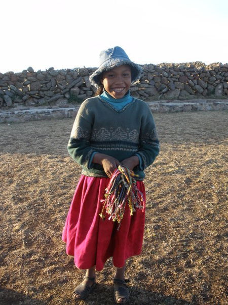 A beautiful orphan girl selling bracelets