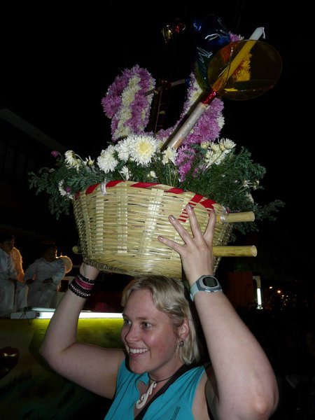 Merryn trying to carry one of the flower displays.  Weighs a tonne!  And they walk around with these on their heads for hours during the procession.
