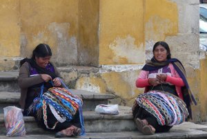 Two ladies making and selling their goods in the city square