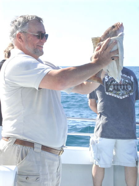 Don't try this at home---Wes is holding a grouper he caught - there are over 5 ways that this fish can do bodily harm!
