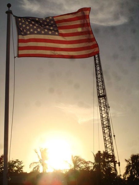 Sunset with an American Flag and a Work Boat Crane, Goodland, Fl.