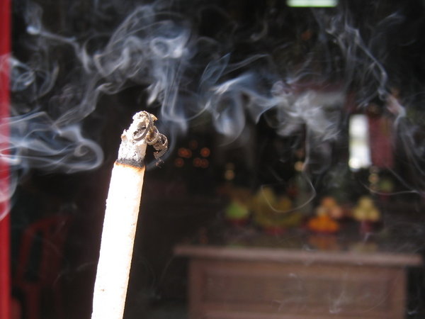 Melaka: burning incense at the Chinese temple
