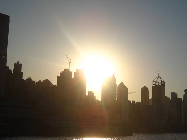 skyline from the other side with sun going down behind hongkong island