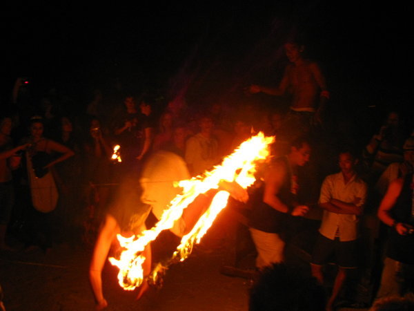 People jumping through the burning ring of fire