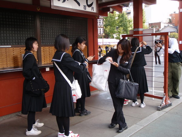 We saw some girls doing something with pieces of paper outside the temple in Asakusa. We asked what they were doing and they explained how it worked...